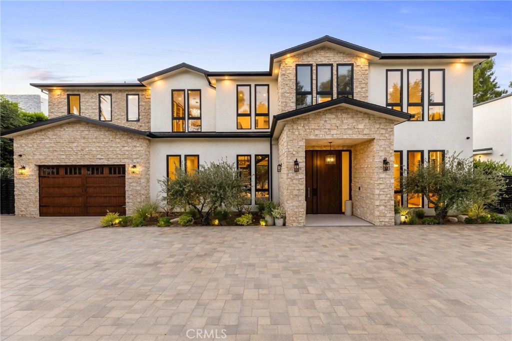 Welcome to this breathtaking newly built estate, where timeless Tuscan elegance meets modern sophistication. Privately gated and ideally located south of the Boulevard in prime Tarzana, this luxurious home offers 6 bedrooms and 7.5 bathrooms, curated with refined design, designer details, and advanced smart home technology.
The main residence features 5 en-suite bedrooms and 5.5 baths, introduced by a commanding 10-foot solid wood pivot door and a dramatic floating staircase. A striking atrium with a faux olive tree brings warmth and natural texture, while the adjacent sitting area offers a stylish space to relax or welcome guests.
The open-concept living area boasts a sleek fireplace, faux wood beam ceilings, and expansive pocket doors that seamlessly connect to the oversized covered patio—outfitted with built-in heaters and a full outdoor BBQ kitchen, perfect for entertaining. The gourmet kitchen is a chef’s dream with Dacor appliances, built-in fridge and freezer, wine fridge, and a separate butler’s pantry with espresso machine, sink, second dishwasher, and ample storage.
Additional highlights include a formal dining room with custom cabinetry, a media room with projector and screen, and a private home office. Upstairs, the showstopping primary suite offers vaulted ceilings with beam accents, a fireplace, pocket doors to a private balcony, and a custom walk-in closet with built-ins, a lighted makeup vanity, and jewelry drawers. The spa-like bath includes dual sinks, a freestanding soaking tub, oversized shower, and an infrared sauna—rivaling any luxury resort.
Smart home automation via Control4 controls custom lighting, surround sound, and more—ensuring comfort and convenience at every turn. Step outside into your own resort-style retreat featuring a sparkling pool and spa, basketball sport court, and a stunning cabana with three walls of bi-folding glass doors.
Completing the estate is a detached ADU with full kitchen, laundry, one bedroom, and two full bathrooms—finished to the same high standards as the main home.
This is luxury living reimagined in one of Tarzana’s most sought-after neighborhoods.