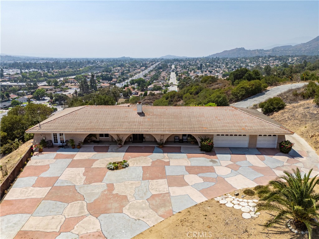 Welcome to this versatile single-story ranch home nestled in the foothills of La Verne. offering approximately 2,800 sq. ft. of thoughtfully designed living space within a private, multi-million dollar gated community. This residence combines comfort, functionality, and flexible layouts to suit a variety of lifestyles. The main living area features a spacious open-concept design with a sunlit living room, cozy fireplace, and large windows framing serene mountain and city light views of the San Gabriel Valley. The adjoining kitchen creates a natural hub for daily life and gatherings. The generous primary suite includes an expansive closet, a large full bath with separate soaking tub and shower and sliding doors leading to private outdoor views. This home also offers flexible living arrangements, including a separate studio-style suite with its own kitchenette, as well as an additional one-bedroom wing complete with its own bath, kitchenette, and private patio. These independent spaces are perfect for multigenerational living, guest accommodations, or income-producing opportunities all while maintaining privacy and comfort. Property is currently being used as 3 units and can be converted back to a single-family residence. Additional highlights include a 3-car garage, multiple private patios, in a secure and tranquil environment. Conveniently located near schools, parks, shopping, and dining, this property seamlessly blends everyday practicality with room to grow.