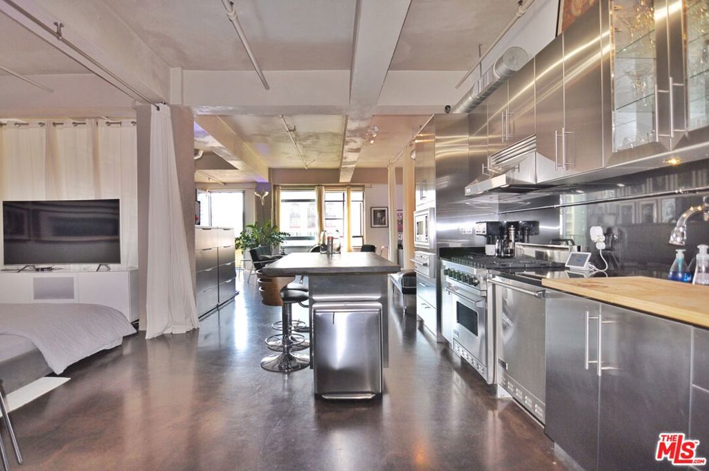 Nearly 1200sf updated LIVE/WORK loft w/balcony situated in the iconic Eastern Columbia building. This spacious loft high on the 10th floor features the best L-shaped layout with soaring ceilings and massive west-facing windows that let in an abundance of natural light. The NYC style loft features polished concrete floors throughout, and a flexible open floorplan to create multiple bedroom/office areas. Sleek stainless steel kitchen with Viking cooking appliances and a kitchen island with plenty of storage. Enjoy city and sunset views of downtown from a private balcony off the living area. There is a wall-to-wall closet in the bedroom, and a closet in entryway with laundry hookups. The Kelly Wearstler designed bathroom features a soaking tub. 1 covered parking space is included with the unit. HOA Dues include parking, water, trash, gas.The Eastern Columbia has a stunning rooftop pool, sun deck, spa, and fitness center with breathtaking views of DTLA, community laundry room, courtyard and mini dog run. Stunning lobby with a 24/7 reception desk and security, and attached parking garage. Within blocks to everything including Whole Foods, Fashion District, Orpheum, Proper and Hoxton hotels, Metro, The Broad, IL Caffe, Zinque, Walt Disney Concert Hall, The Bloc, Fashion District, City Market South, Grand Central Market, and more.