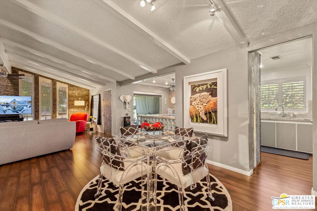 Framed by beautiful golf course views and mountain panoramas, this impressive move-in-ready fairway residence is destined to sell at Palm Desert's gated Suncrest Country Club, which is reserved for those who are 55 and better. The spacious triple-wide design extends approximately 1,920 square feet over one level and impresses with a large living room with fireplace, views and floor-to-ceiling windows. Living areas flow effortlessly to a chic walk-in wet bar and a dining room with built-in buffet and mirrored display shelves. Light and open with a vaulted and beamed ceiling, the interior is enviably private and welcomes fabulous entertaining and simple relaxation. Completely reimagined, the open kitchen is adorned with artistic stainless steel wall panels, granite countertops, mosaic tile, a breakfast bar, access to a covered patio, crown molding, a walk-in pantry and stainless steel appliances. Two bedrooms and two upgraded baths are showcased, with the secondary bedroom currently featured as a massive walk-in closet with furniture-caliber built-ins. This room can easily be transformed back into a bedroom. An opulent sanctuary, the primary suite displays a custom accent wall, custom office with built-in desk and cabinets, and a spacious remodeled bath with soaking tub, walk-in shower and separate sinks. Extras include solar power, a security system, whole house audio, plantation shutters and a newer roof. The backyard is located directly on the edge of the golf course, providing gorgeous unobstructed views from two covered patios. For added convenience, the home's carport accommodates two vehicles. Located in the heart of Palm Desert, Suncrest Country Club presents a luxurious clubhouse with billiards, library, locker rooms, pro shop and cafe. Residents enjoy easy access to a trio of swimming pools, in-ground spas, lighted tennis and pickleball courts, and a gorgeous 9-hole golf course. Premium resorts, abundant shopping, countless restaurants, and Eisenhower Medical Center are moments away, and Rancho Mirage and Palm Springs are nearby.