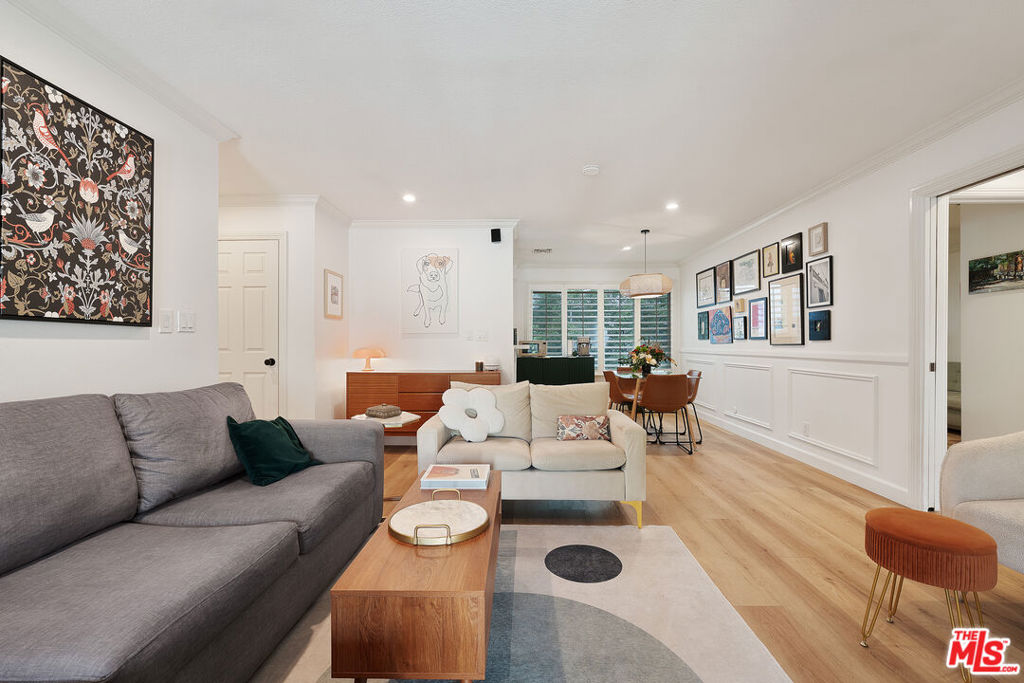 Located in one of Studio City's most serene, lush corners, this beautifully updated top floor condo offers peace and privacy with serene views of the surrounding greenery. Featuring brand-new luxury vinyl flooring, dual-paned windows, in-unit laundry, and newer central HVAC, this home is move-in ready. The remodeled bathrooms boast modern finishes, and the kitchen features high-end appliances and thoughtful design. Enjoy the spacious front balcony, perfect for dining, relaxing, or morning coffee. The open floor plan flows seamlessly, with well-proportioned rooms and great storage throughout, including a dedicated storage locker in the carport. Additional upgrades include a built-in surround sound system and a recently replaced roof. The dog-friendly complex offers resort-style amenities: a large pool, spa, and a grassy dog run just steps away. Ample guest parking is available. HOA dues cover water, landscaping and insurance. Just minutes from Ventura Blvd, Tujunga Village, and Studio City's best shopping, dining, and entertainment.