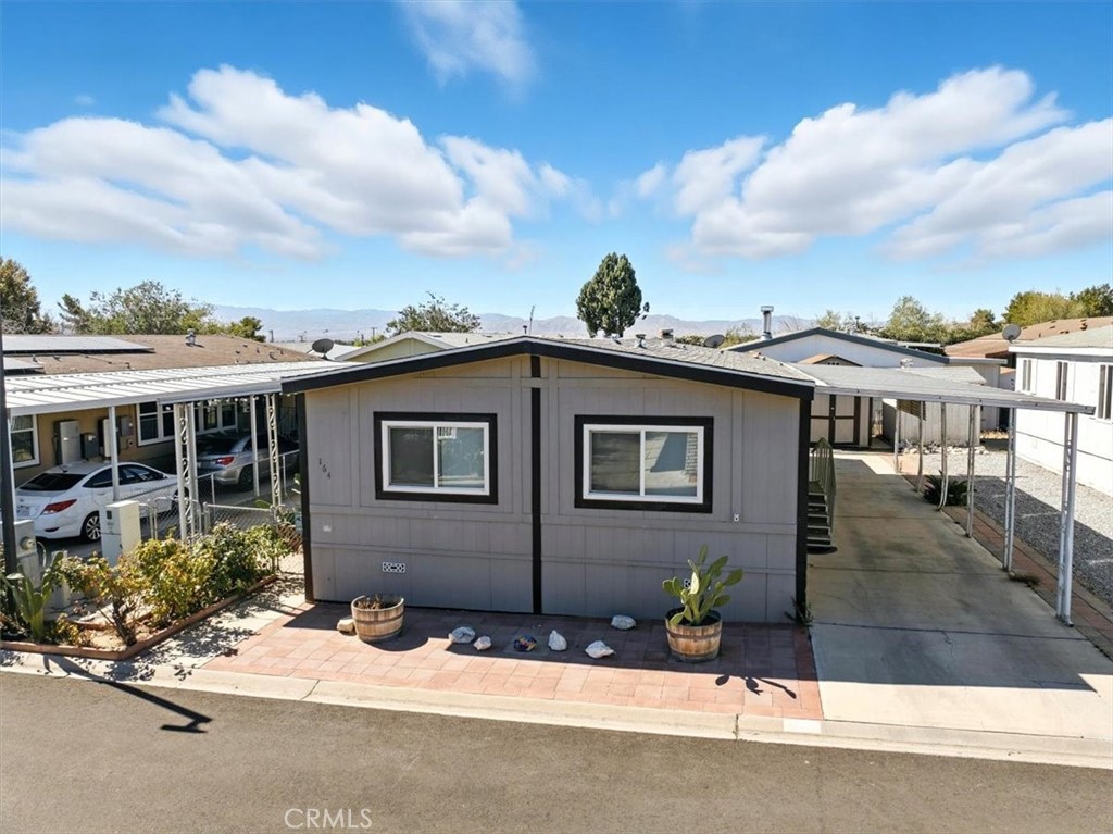 Welcome to this modern mobile home that has been thoughtfully updated both inside and out, offering a fresh and inviting living experience. Tucked within a calm and welcoming family community, this home provides a sense of comfort and peace while still being conveniently located near everyday necessities.
Inside, you’ll find 2 generously sized bedrooms and 2 full bathrooms, each designed with ample space and functionality in mind. The open layout allows for easy flow between living areas, creating a warm environment for family time or hosting guests.
The carport comfortably fits up to 3 vehicles, adding convenience and flexibility for homeowners. What truly sets this property apart is its rare and spacious backyard — one of the largest in the community. This outdoor retreat is perfect for recreation, entertaining, gardening, or simply relaxing in a private setting.