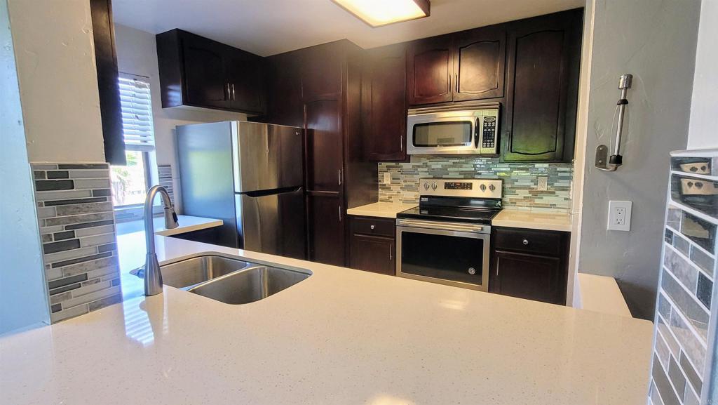 Magnificently remodeled condo with a view of the golf course. Newly installed wide plank high-end flooring and baseboards (no carpet). The kitchen was beautifully remodeled at an earlier date. Furniture in the current pictures will convey if the tenant would like it to stay. Full size washer & dryer included in closet in unit. Newly painted throughout on the vertical walls in the rooms. Upgraded showers. Beautiful community pool & spa. 2 assigned tandem garage parking spots very close to unit. Secure gated complex. Gas fireplace in living room. Large balcony. Close to terrific beaches, shopping, restaurants, and entertainment. No smoking.