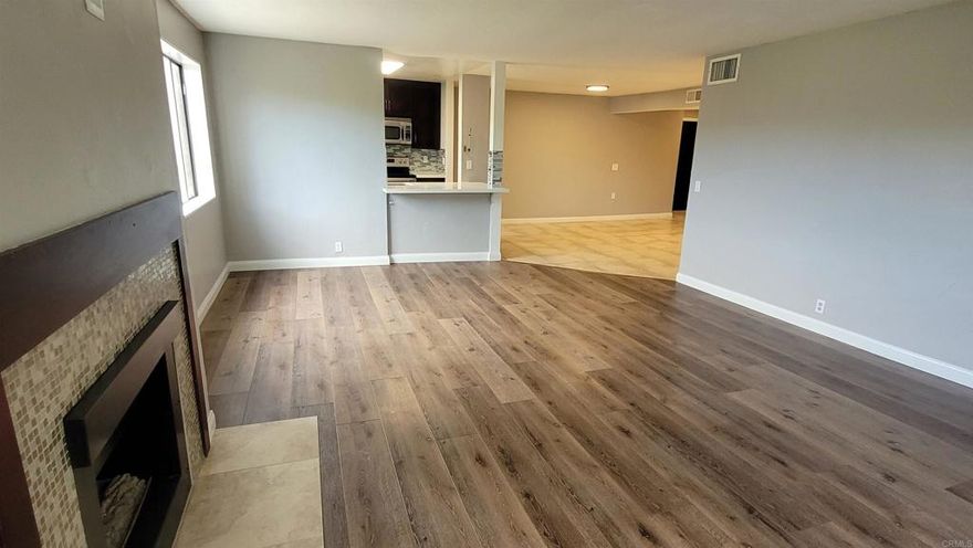 Magnificently remodeled condo with a view of the golf course. Newly installed wide plank high-end flooring and baseboards (no carpet). The kitchen was beautifully remodeled at an earlier date. Furniture in the current pictures will convey if the tenant would like it to stay. Full size washer & dryer included in closet in unit. Newly painted throughout on the vertical walls in the rooms. Upgraded showers. Beautiful community pool & spa.  2 assigned tandem garage parking spots very close to unit. Secure gated complex. Gas fireplace in living room. Large balcony. Close to terrific beaches, shopping, restaurants, and entertainment. No smoking.