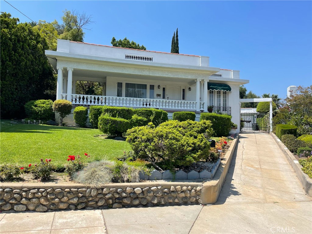 Discover timeless elegance in this beautifully maintained three-bedroom, two-bathroom home in the heart of Pasadena. Built in 1923, this charming single-level residence offers approx. 1,661 sq ft of living space on a spacious 7,981 sq ft lot. A stately façade with classic columns, balustrade railings, and a wide front porch welcomes you to relax and enjoy the peaceful, tree-lined street.
Inside, the sunlit layout features spacious living and dining rooms with original character and a cozy fireplace, offering warmth and charm. The well-proportioned bedrooms provide comfort for family or guests, while the kitchen offers exciting potential for updates.
The backyard is a private oasis with a large covered gazebo, tiled patio, and beautifully landscaped gardens with winding stone pathways — perfect for entertaining or quiet afternoons. A detached one-car garage and gated driveway complete this exceptional property, set in one of Pasadena’s most desirable neighborhoods near shops, dining, and cultural landmarks.
This is a rare opportunity to own a piece of Pasadena history with classic architecture and a magical outdoor retreat.
