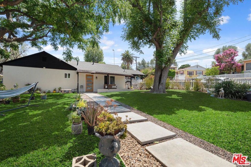 Move right in and start enjoying this Sunland gem; fully updated, beautifully maintained, and sitting on a generous corner lot. This 2-bedroom, 2-bath home offers 800 sq ft of comfortable living space, designed with convenience and style in mind. The remodeled kitchen and bathrooms shine with modern finishes, while upgraded flooring, recessed lighting, and dual-pane windows add both comfort and charm. Central AC ensures refreshing comfort indoors, even during record-breaking heat! Freshly painted inside and out, this property feels brand new. Outside, the spacious 5,061 sq ft lot offers endless possibilities; expand the main home, build an ADU, or design your dream outdoor retreat. Mature trees and a classic white picket fence create instant curb appeal, while two storage sheds, a covered carport, and ample off-street parking provide everyday practicality. Turn-key and move-in ready, this home is perfect for buyers who want value, comfort, and opportunity all in one. Located in a peaceful neighborhood just minutes from local parks, trails, golf, and shopping.