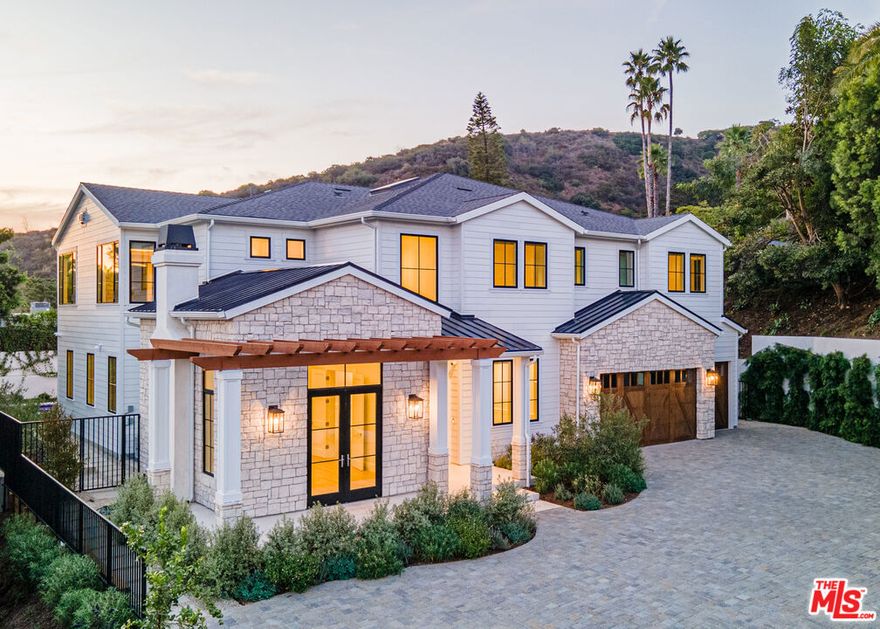 Privately set on a gated flag lot in Beverly Crest, this newly built Beverly Hills home blends timeless California Craftsman style with Cape Cod elegance. Elevated above the street for added seclusion, it features top-of-the-line finishes including hardwood floors, marble surfaces, designer lighting, custom millwork, and surround sound. The open floor plan includes a gourmet kitchen with dual islands, breakfast nook, and premium appliances, flowing into a spacious living area with large sliding doors that open to a private backyard with a pool, spa, lawn, and patio. A flexible office or guest room with fireplace sits near the entry, and a detached bonus space offers use as a gym, studio, or guest suite. Upstairs, the luxurious primary suite includes a fireplace, balcony with canyon views, spa-like bath, and walk-in closet. Located minutes from top-tier shopping, dining, and entertainment, this home offers luxury, privacy, and exceptional design in a coveted location.