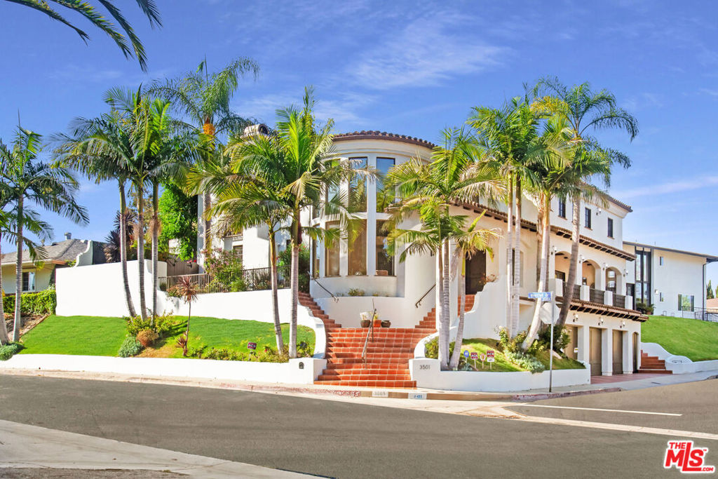 Perched high above the street in the coveted Royal Hills of Encino, this magnificent modern Mediterranean villa offers unrivaled privacy, natural light, and dramatic curb appeal. Completely rebuilt in 2007, this architectural gem blends old-world craftsmanship with luxurious contemporary living, featuring bespoke finishes, intricately carved wood doors, coved ceilings, and gleaming wood and travertine floors throughout.Enter through a grand two-story foyer into an expansive living room flooded with natural light. The formal dining room with its own balcony sets the stage for elegant gatherings, while a second family room offers warmth and intimacy. The heart of the home is a stunning chef's kitchen with an oversized island, double ovens, double sinks, a large pantry, wine fridge, and abundant storageideal for entertaining or everyday luxury. The adjacent breakfast area opens to a lush backyard through double French doors, revealing a sparkling pool with fountain features, a cozy gazebo for shady respite, and a grassy play area, all perfect for al fresco dining and relaxation. Upstairs, a private staircase leads to a gracious landing and a sprawling primary suite retreat, complete with fireplace, dual walk-in closets, and a spa-inspired bath with a jetted tub, double shower, and dual vanities. Two additional upstairs bedrooms each enjoy en-suite baths, while the main level offers two more bedrooms, ideal for guests or home office use. A three-car garage and a private elevator provide direct, convenient access to the main living level, completing this exquisite and thoughtfully designed estate. The prestigious Royal Hills neighborhood is well located to many commuter roads to the Westside and to the Valley, as well as private schools and the coveted Lanai school district.