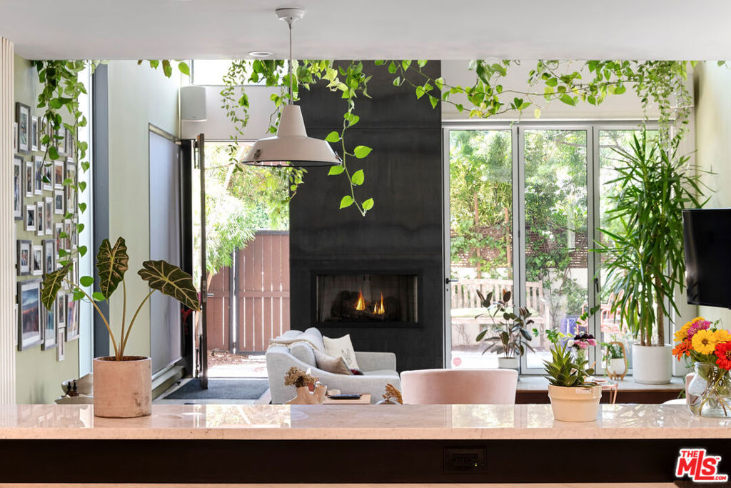 Step into The Venice Green House, a home that embodies the essence of Southern California living, this architectural masterpiece offers 3,154 square feet of inspired design, ideally positioned between Abbot Kinney, the Venice Canals and the beach, just steps from neighborhood hotspots like Great White and the Hume Wellness Club.With impeccable craftsmanship and high-end finishes throughout, the home welcomes you through a private 2-car garage, with EV charging, into a spacious, light-filled interior.A striking combination of Brazilian cherrywood & polished concrete flooring with a custom living plant wall sets a sophisticated tone, while custom mahogany cabinetry adds warmth and elegance throughout. Towering double-height ceilings and expansive windows flood the main level with natural light, creating an open and inviting atmosphere. The gourmet kitchen is outfitted with top-of-the-line stainless steel appliances and designed for both everyday functionality and elevated entertaining.On the 2nd floor, the 4th bedroom which is currently being used as a custom floating music studio/ media room adds creative flexibility. This level also includes a mezzanine lounge and a convenient laundry and A/V room.On the third floor, you'll find three generously sized bedrooms, including a sun-drenched primary suite featuring a fireplace, skylights, a custom-built closet, soaking tub and private balcony as well as a newer steam shower and skylight in the 2nd bathroom and another private balcony with custom-built closet in the second bedroom. The rooftop deck crowns the home with more lush greenery, an outdoor kitchen, and a built-in grill, offering sweeping 360-degree views of the city and surrounding mountains.This one-of-a-kind residence is a rare opportunity to experience luxury coastal living in one of Venice's most coveted enclaves.