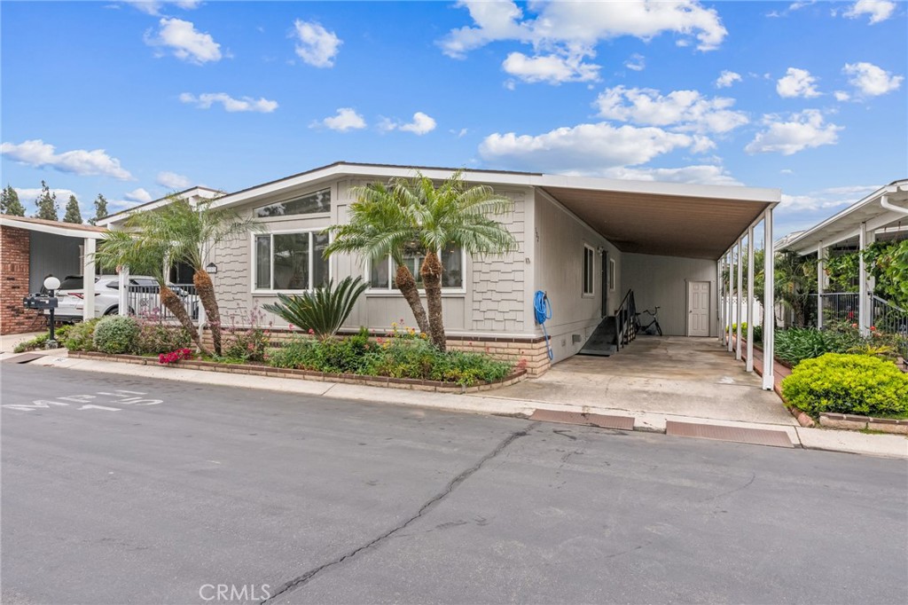 Price Improvement! Welcome to The Groves, Irvine’s premier active senior community! This beautifully updated 2-bedroom, 2-bath home is perfectly situated on a premium lot at the rear of the neighborhood, offering peace, privacy, and minimal traffic. Step inside to discover a fully renovated interior, featuring new luxury vinyl plank flooring throughout and a stunning, designer kitchen complete with white cabinetry, quartz countertops, a large center island with seating, stainless steel appliances, and contemporary lighting fixtures with open floor concept. The upgrades continue in the spacious primary suite where you’ll find dual porcelain sinks, motion-sensor lit mirrors, and modern finishes. Outside, enjoy a welcoming front patio — perfect for relaxing and greeting neighbors — along with a backyard shed providing extra storage space. The Groves is a resident-owned community — no space rent — and your purchase includes a Membership Certificate in the Corporation that owns the land. Amenities are truly exceptional, featuring a year-round heated pool and spa, fitness center, tennis and basketball courts, lawn bowling, banquet facilities, hair salon, RV storage, community gardens, a 7-acre park with covered pavilions and BBQ areas, a 9-hole putting green, woodshop, ceramics studio, and more. On-site management and a full-time activities coordinator ensure a vibrant and engaging community life. Located in Irvine — consistently ranked as one of America’s safest cities — The Groves offers low HOA fees and discounted Cox internet and TV service to all residents. Move right in and start enjoying a beautiful lifestyle today! The sellers are highly motivated.