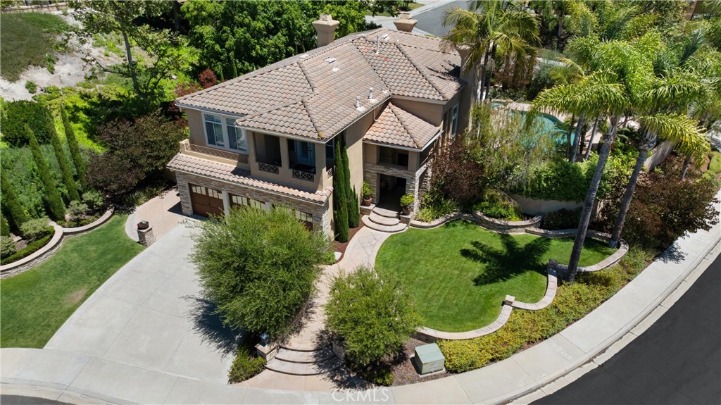 ***Note: Exclusive Location - No Neighbors Directly on Either Side of the Home for Ultimate Privacy - Potential for 5th bedroom*** Welcome to 27321 Cloverly Drive – A Private Estate in One of Mission Viejo’s Most Coveted Communities, Pacific Hills. Tucked away on an exclusive cul-de-sac, this stunning 4-bedroom, 4-bathroom home offers nearly 3,500 square feet of refined living space on an oversized, premier corner lot with no direct neighbors—ensuring unrivaled privacy and tranquility. Step into your resort-style backyard oasis, where the luxurious ambiance comes alive. Designed for entertaining and relaxing alike, this show-stopping yard features a sparkling pool and spa, built-in BBQ island, fireplace, outdoor TV, and an expansive covered patio, ready to host outdoor gatherings of any size. It’s your own vacation getaway—right at home. Inside, you'll be captivated by soaring ceilings, an abundance of natural light, and thoughtfully designed spaces. The kitchen is a dream, boasting stainless appliances, cooktop, double oven, a large commercial-grade refrigerator, a spacious island, and custom cabinetry. The formal living and dining rooms feature dramatic ceiling heights and oversized windows that frame the beauty of the backyard. The first-floor bedroom and full bath offer flexibility for guests or multigenerational living, currently curated as a stylish lounge complete with a temperature, and humidity-controlled, wine cellar. Retreat up the impressive staircase to the luxurious primary suite, a true sanctuary with high ceilings, a private balcony overlooking the pool, and a spa-inspired ensuite bathroom featuring a soaking tub, walk-in shower, dual vanities, and his-and-hers walk-in closets. Other notable features of the home include Full HVAC with AC and furnace, large 3 car garage, flexible office and loft space (may be converted to a 5th bedroom) with an attached balcony, water fountain, recessed lighting, ceiling fans, and so much more! Located in one of Mission Viejo’s most sought-after communities, residents enjoy access to top-rated schools, lush parks and trails, proximity to shopping, dining, and Lake Mission Viejo, where you can enjoy entertainment, and lakeside recreation. This exceptional home offers your perfect L3: Location, Luxury, and Lifestyle. Don’t miss your opportunity to own one of the finest properties in Mission Viejo!