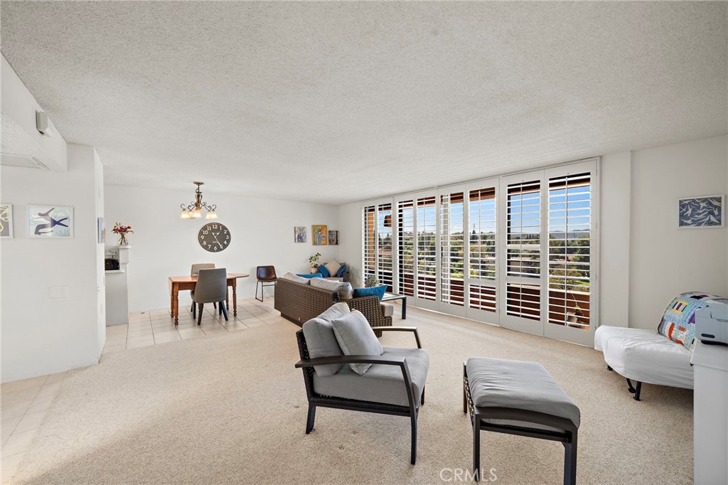 This is a highly sought after "G" floor plan at the Towers, with gorgeous views of the Southern California Sunsets! This home has a huge bedroom and 1.5 bathrooms. The dining room and living room lead to the step out balcony that runs the length of the home. The kitchen has been remodeled and features a 2 burner cook top, fridge plus an added bar with more storage and counter space. The master bedroom is massive and has a walk in closet plus a slider to the deck and an en suite bathroom with shower. The home also features a convenient guest half bathroom at the entry. Located in Laguna Woods, a SENIOR community, the Towers features many amenities. Currently INCLUDED in the monthly fee are: a monthly $500 dining credit to use in the 2 dining rooms, housekeeping, electiricty, water, trash, basic cable, plus on site activities: live entertainment, bingo, movies, exercise classes, card rooms, parties & more! Living in Laguna Woods means access to a bus system around the community, to area shopping, restaurants, medical facilities; 5 pools & 4 hot tubs; 27-hole golf course, tennis, library, state-of-the art crafts facility, 7 clubhouses, 200+ clubs, 3 fitness centers, theater, horseback riding/stables, garden centers, basketball, billiards, bocce ball, Emeritus classes & more! Come enjoy resort style living at its best!