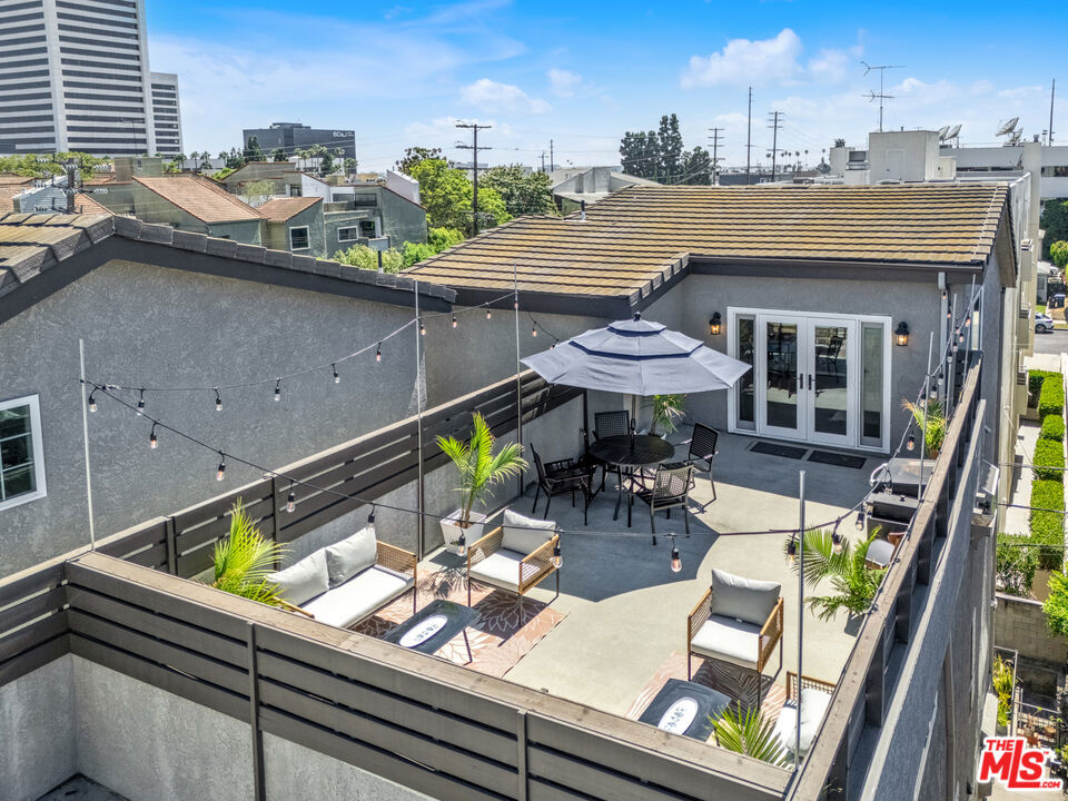 This stunning architectural 2-bed, 3-bath penthouse in Westwood has it all! Soaring ceilings and new Milgard oversized sliding doors and windows bring an abundance of light throughout this home. A balcony runs the length of the unit, adding to the indoor and outdoor feel, and the living room has a sleek fireplace and plenty of wall space for artwork. You'll find maple cabinets, granite countertops, and a window ledge for succulents or herbs in the kitchen. Downstairs you'll find 2 generously sized bedrooms, 2 bathrooms, and an in-unit laundry area. The larger bedroom has a romantic fireplace and ensuite bathroom. Upstairs you'll find a large loft, a 3rd bathroom, and french doors that open to a 460 sq ft (approximate) PRIVATE rooftop deck. This boutique building has 7 units and is located on a charming, tree-lined cul-de-sac street. It is situated in the Fairburn School district, just steps from neighborhood parks, Westwood Village, and the planned Metro Purple line. This exceptional property won't last long!