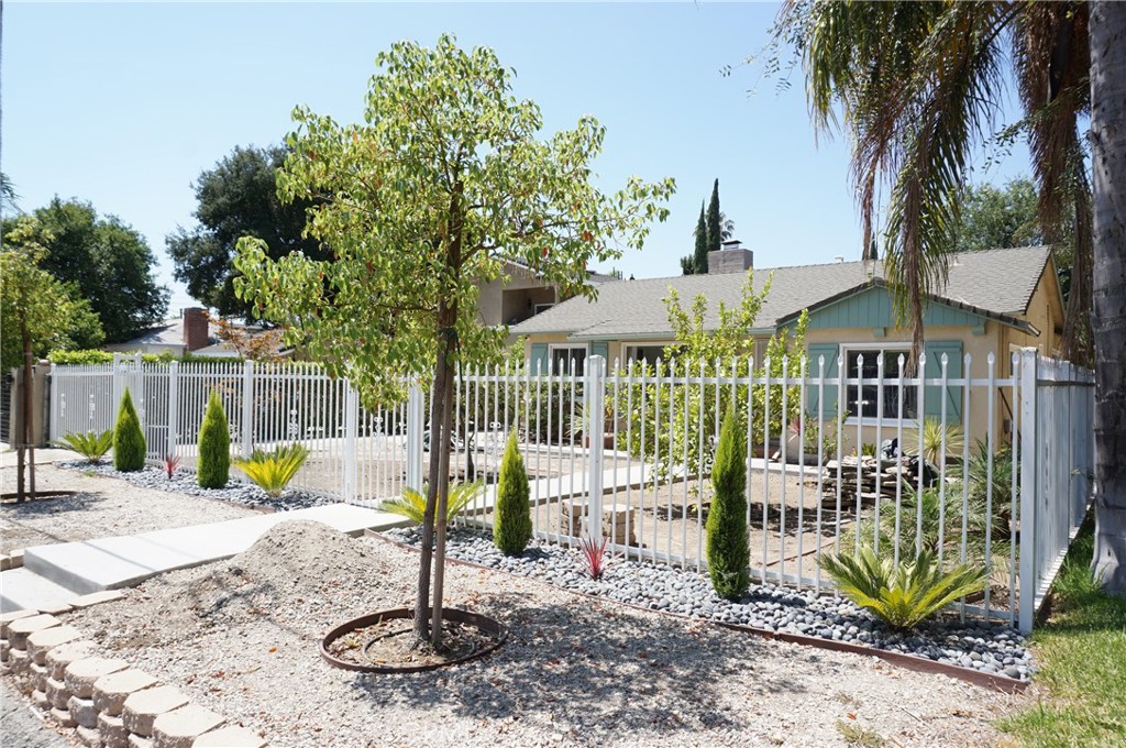 Charming gated Single-Story Home for Rent in Chatsworth! This spacious 3-bedroom, 2-bathroom home offers 1,468 sq. ft. of comfortable living space. Step into a bright and welcoming living room featuring a cozy fireplace, fresh paint, new carpet, recessed lighting, and dual-pane windows. The kitchen boasts ample cabinet space with timeless charm, granite countertops, and includes a cooktop, oven, dishwasher, and refrigerator. Adjacent to the kitchen, the oversized family room showcases built-in bookshelves, laminate flooring, and a cheerful breakfast nook with plenty of natural light. The primary bedroom has its own private entrance and ensuite bath, while the two additional bedrooms feature new carpet, ceiling fans, recessed lighting, and share a full bath with tub and shower. Central AC/heat, long driveway with detached 2-car garage. Spacious backyard with covered patio – perfect for outdoor enjoyment. Prime location with easy access to the 118 freeway, Metrolink, shopping, dining, grocery stores, coffee shops, entertainment, and just minutes from Westfield Topanga Mall & The Village. Sorry, no pets!