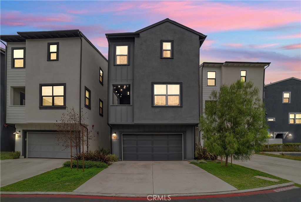 Welcome to Twenty8 Walk, a private gated enclave of detached condos in the heart of vibrant Costa Mesa. This stunning residence features one of the community’s most coveted floor plans, enhanced by designer upgrades and smart-home features throughout. The entry level includes a spacious en-suite bedroom with direct access to a beautifully landscaped yard (the largest in the development) complete with custom hardscape, a lush garden, and a built-in sprinkler system—an inviting retreat, office or ideal guest space. The attached two-car garage includes a Tesla charger port. Upstairs, the open-concept main level is an entertainer’s dream, showcasing a chef’s kitchen with Arabescato Como quartz counters and backsplash, a generous island with bar seating, soft-close shaker cabinetry, a Western Pottery farm sink, and a built-in wine cooler. Premium Samsung stainless steel appliances, a Moen matte black fixture suite, and a reverse osmosis water system add both style and function. The spacious great room is fitted with an upgraded audio package featuring in-ceiling speakers, plus access to a private enclosed balcony and a convenient powder room. The top floor offers a luxurious primary suite with a walk-in closet and an upgraded spa-style bath with a frameless glass enclosure and oversized 10" rain shower head. Two additional bedrooms share a stylish Jack-and-Jill bathroom, and the home features upgraded Heritage Collection interior doors throughout. Additional highlights include a Nest Hello doorbell, leased solar system, and a Samsung smart washer and gas dryer (negotiable). Ideally located minutes from Newport Beach, top schools, shopping, golf, and dining, this turnkey home blends modern luxury with everyday comfort.