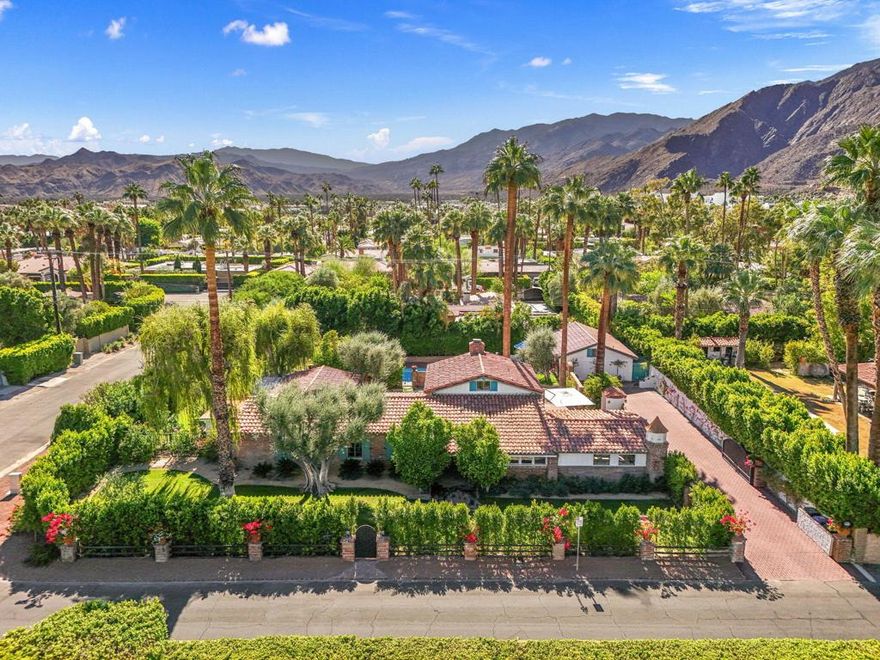 Welcome to this exquisite 1936 Spanish Colonial beauty, ideally located in the heart of the historic Movie Colony. Thoughtfully enhanced with modern upgrades while preserving its timeless character, this home offers the perfect blend of vintage charm and contemporary luxury. The recently renovated bathrooms have been reimagined with refined, modern finishes that complement the home's classic aesthetic, creating spaces that are both elegant and functional. The kitchen, beautifully updated, maintains its original character while offering today's conveniences. Beamed ceilings and deep red Saltillo tiles add warmth and authenticity, a hallmark of Spanish Colonial design. A newly constructed casita provides versatility for guests or extended stays, offering privacy and comfort. The backyard is a private desert retreat, featuring panoramic mountain views, a sparkling pool, an above-ground spa, a covered lounge with a classic brick firepit, and a dining area perfect for entertaining or relaxing under the stars. Set on an oversized corner lot surrounded by lush landscaping, citrus trees, and a privacy hedge, this home captures the essence of Palm Springs living. Just moments from Downtown Palm Springs, acclaimed restaurants, boutiques, and Ruth Hardy Park, this is an amazing opportunity to own a piece of Palm Springs history, reimagined for modern living.