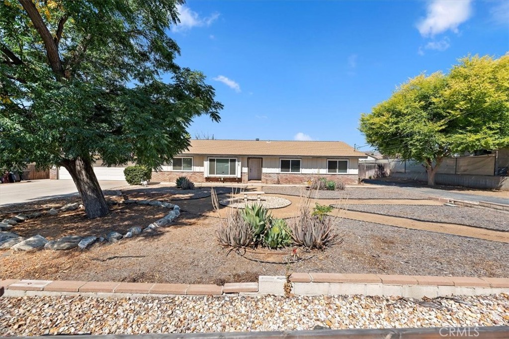 If you're looking for an updated family home with just under an acre lot of flat, usable space, this is the house you've been looking for! According to the city, this large lot can be subdivided into a total of 3 lots, with access to a cul-de-sac street at the back of the yard. This large lot provides plenty of potential to build on or design the backyard oasis of your dreams. The property already has an in-ground pool and spa, with an expansive covered patio and extended driveway into the backyard for multi-purpose parking. The widened, lengthy front driveway has even more areas for parking with an attached 3-car garage. And for easy yard maintenance, the front and back yards have draught-tolerated plantings and hardscapes. Once inside the home, you will find plenty of natural light and ample space for your family with 4 bedrooms, 3 bathrooms, a spacious living room and dining area and an updated, open-concept kitchen with an island overlooking the family room and pool with full access to the patio area. The inviting family room has a wood beamed ceiling with a large brick fireplace, perfect for cozying up on those cold winter nights and movie watching with the family. Newer flooring, baseboards and paint throughout, with all bathrooms and kitchen completely remodeled with modern fixtures. This home is move-in ready and just waiting for its new owners!