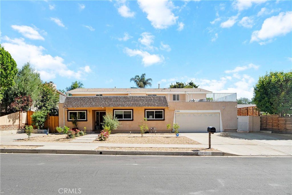 Elegance and sophistication come together in this spacious home located in Granada Hills. Welcoming curb appeal with drought tolerant landscaping and inviting pathways lead to this 5 bedrooms, 5.5 bathrooms home with over 4,100 square feet of living space on an 8,654 square foot lot. Grand entry with high ceilings, travertine tile floors and storage cabinets lead to a sumptuous living room and family room area with open spaces and versatile floor plan. Living room is adjacent to wet bar—great for entertaining! Family room with sliding glass door leads to an enclosed patio (with its own separate access) that could be perfect for a game room, exercise room or office. The formal dining area flows seamlessly to a sun filled kitchen with tranquil views of O’Melveny Park through large picturesque windows. Light and bright kitchen features granite countertops, Thermador built-in range & double oven, Zephyr hood, built-in wine racks, tons of storage space and massive center island with built-in breakfast bar. Lower Level also features separate ensuite bedroom with its own bathroom, a laundry closet, additional ¾ bathroom adjacent to family room and an updated powder room. Upper-Level features 4 bedrooms, 3 bathrooms and its own separate water heater. Primary suite is a peaceful getaway featuring laminate wood floors, recessed lighting, and your own private deck with charming views of the backyard. Primary bathroom features dual sinks, large walk-in shower with ceiling mounted showerhead, spa tub and large walk-in closet. Upper-Level also features a junior master with its own bathroom and walk-in closet. Two additional well-sized Jack & Jill bedrooms both feature walk-in closets, share a tub and one of the bedrooms has access to patio overlooking the beautiful, lush park. Additional features include a security system with Magic Viewer 4K & up to 16 cameras, two 5-ton zoned ACs, newly installed roof in 2020, updated electrical in 2020 with LED Lutron light switches, Tesla charger, 220v/50 amp additional charger and an attached two car garage with direct access. Serene and private backyard features covered patio, grapefruit, orange, lemon, sweet lemon, nectarine, almond, apple, blueberry and plum trees. An ideal location near the park, located in a top-rated school district (just minutes to Van Gogh Elementary) and close to shopping, restaurants, easy freeway access and much more. Truly a great opportunity to own an expansive home in a great Granada Hills location.