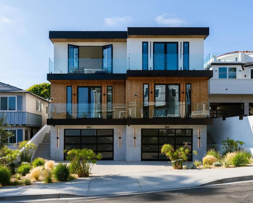 Steps from iconic Windansea Beach, in the highly sought after Beach Barber tract neighborhood, this brand-new custom-built masterpiece blends modern luxury with timeless coastal charm. The main residence offers 4 spacious bedrooms and 4.5 impeccably designed baths, paired with a fully detached 1 bed, 1 bath ADU — ideal for guests, extended family, or flexible rental opportunities. From the moment you enter, you're greeted with soaring ceilings, natural light pouring through expansive windows, and wide-plank white oak flooring that runs throughout. The open-concept living spaces are anchored by stunning custom cabinetry and designer finishes, creating a sophisticated yet relaxed coastal ambiance. The showstopping ocean-view primary suite features panoramic vistas, a spa-inspired bath with soaking tub and walk-in shower, and a generous custom walk-in closet. Retreat upstairs to the expansive roof deck to soak in spectacular whitewater views — perfect for sunset entertaining or quiet moments above the surf. Additional highlights include a 2+ car garage, ample storage for surfboards, beach gear, and bikes, paid solar, custom sound and lighting systems, and seamless indoor-outdoor flow for the ultimate Southern California lifestyle. A rare opportunity to own an architecturally distinct, thoughtfully crafted home just moments from one of La Jolla’s most treasured beaches.