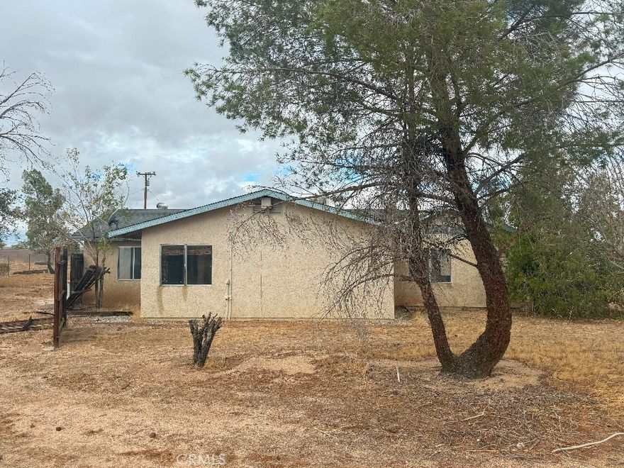 Investor purchase in rural Apple Valley on large lot ready to expand. Structure is decent and in tact though in need of flipping and repairs, debris removal. Was an indoor agricultural grow operation. Barn and bonus rooms on lot, solar field available, large garage and enclosed patio areas, fully fenced lot, views. Cash or hard money only.