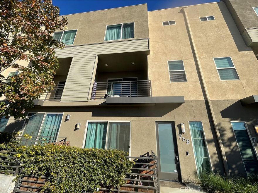 This beautifully designed spacious 3 bedroom, 3.5 bath condo offers modern living.  The first floor features a versatile bonus room, perfect for a home office, gym, guest suite or media room.  The main living level showcases an open-floor kitchen that flows seamlessly into the dining and living areas, all enhanced by high ceilings and abundant natural light.  The three bedrooms are located on the top floor and provide amazing lighting.  A separate laundry room adds convenience and organization to everyday living. Multiple balconies offer inviting outdoor spaces to relax and enjoy.  The attached two car garage includes a car charger, ideal for electric vehicle owners.  Stylish, functional, and perfect for relaxation, this home is designed for comfortable contemporary living.