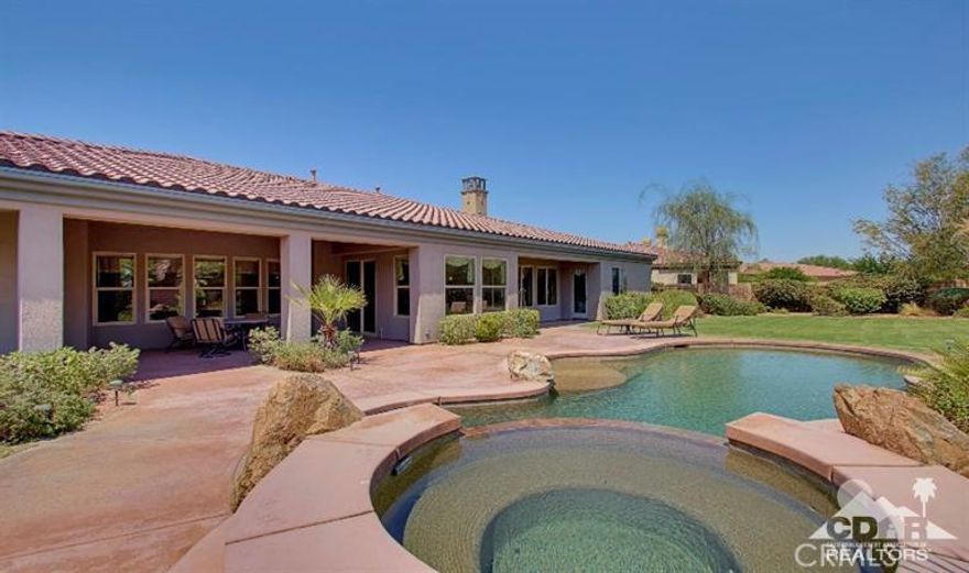 Rare opportunity at sought-after Stone Gate community. Immaculate, rarely used 2nd home; perfect condition! Entertainer's dream! 4 bedrooms are en suites - 2 bedrooms w/ patio access & SW mountain views. Master Suite w/ double-door walk-in closet & double vanity. Grand foyer leads into formal dining & entertaining rm w/ bar. Large family room; island gourmet kitchen w/ granite counters, SS GE Monogram appliances including built-in fridge. Open living room/kitchen concept provides a perfect space for guests to gather around the centerpiece fireplace & built-in entertainment center while enjoying surround sound. The patio, pebble-tec pool/spa, palm trees & lush landscaping including fruit trees come together to complete the ultimate desert lifestyle. 3-car garage & expansive driveway. Furnished per inventory list w/ fine quality furnishings. Location! Location! At end of quiet cul-de-sac on one of the larger lots. Virtually everything desert buyers are looking for!