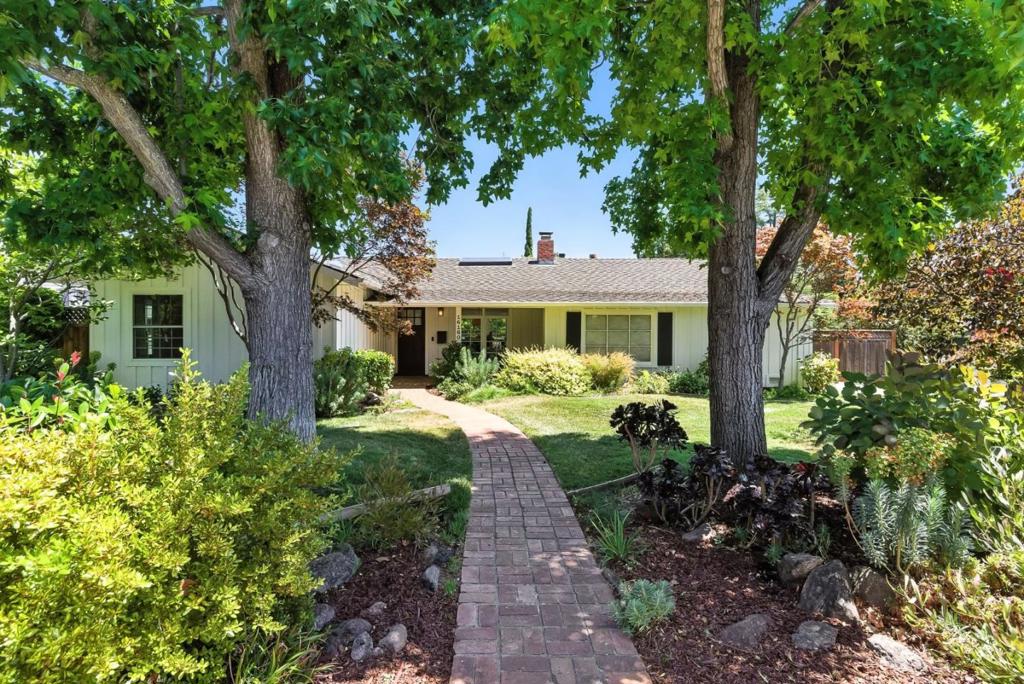 Welcome to this beautiful ranch style home nestled in the highly sought-after Blossom Manor neighborhood. The single-story home spans 2,571 sq ft, and is beautifully situated on a 10,000+ sq ft corner lot. Step inside to discover a harmonious floor plan that seamlessly blends sophistication with comfort. Natural light bathes the interiors, enhancing the welcoming ambiance of the space. The formal living room is adorned with a fireplace, built-in shelving and flows into the formal dining area. Continue into the kitchen that features a large island and open flow into the grand family room with vaulted ceilings, built-in shelving and a fireplace. The private primary bedroom suite is generously sized, overlooking the rear yard and pool. The ensuite bathroom includes an oversized double shower, dual vanity, and walk-in closet. Two additional bedrooms and a custom office space are located on their own separate hallway. The backyard boasts mature landscaping, low-maintenance turf, and elegant hardscape surrounding the pool and spa. Entertain effortlessly with the outdoor kitchen, complete with a built-in BBQ, shaded pergola and fireplace. Close proximity to downtown Los Gatos. TOP RATED Los Gatos schools and quick access to HWY 17 and 85. Do not miss this rare Los Gatos gem!