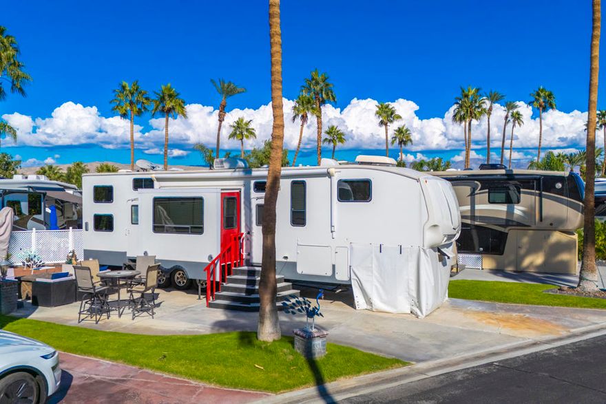 Beautiful RV & Lot Package in Highly Desirable ORPS!Welcome to your perfect desert getaway�an ideal retreat for hosting family and friends. This offering features a spacious 2009 Keystone Fuzion weekender/car hauler, providing two bedrooms and comfortable sleeping accommodations for 8-10 guests. Whether you're welcoming visitors or enjoying a relaxing escape, this versatile setup delivers comfort and convenience.  This is turnkey inside and out.Step outside to an inviting outdoor living space complete with a firepit, dining table with chairs, a cantilever umbrella, and a cozy sectional, creating the perfect setting for morning coffee, evening gatherings, or peaceful relaxation. The lot offers added privacy with a beautiful hedge along the back, enhancing the tranquil atmosphere.Located just steps from Satellite B, you'll enjoy immediate access to a pool, spa, tennis court, laundry facility, and bathrooms with showers�everything you need for resort-style living in the heart of ORPS.Don't miss this move-in ready RV and lot package�your Palm Springs lifestyle awaits!Outdoor Resorts Palm Springs is a Five Star RV Resort Community combining luxury with affordability. It is a guard gated resort that sits on 137 beautifully landscaped acres with 27 holes of executive golf, 10 tennis courts, 13 pickleball courts, 8 swimming pools, a fully equipped fitness center, sports bar, beauty salon/barber shop, full-service restaurant, 2 club houses, activities, special events and so much more.