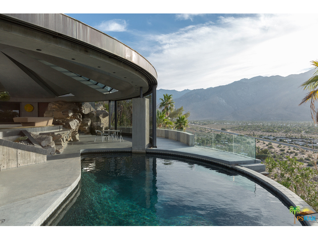 Known as the Elrod House this monumental, world famous residential sculpture was designed by 1968. Organic shapes, monumental construction and world class design create an extraordinary experience of space that Lautner himself described as "timeless" architecture. The 60' wide circular living room has a conical dome that fans out in nine petals between nine clerestories angled up to bring in light. Retractable curved glass walls open the entire living room and pool terrace to panoramic views of Mt San Jacinto, Mt San Gorgonio and the full sweep of the valley below and mountain ranges beyond. The very rock of the ridge is incorporated into the design throughout the home. A very rare opportunity to acquire an inspiring example of architectural perfection.