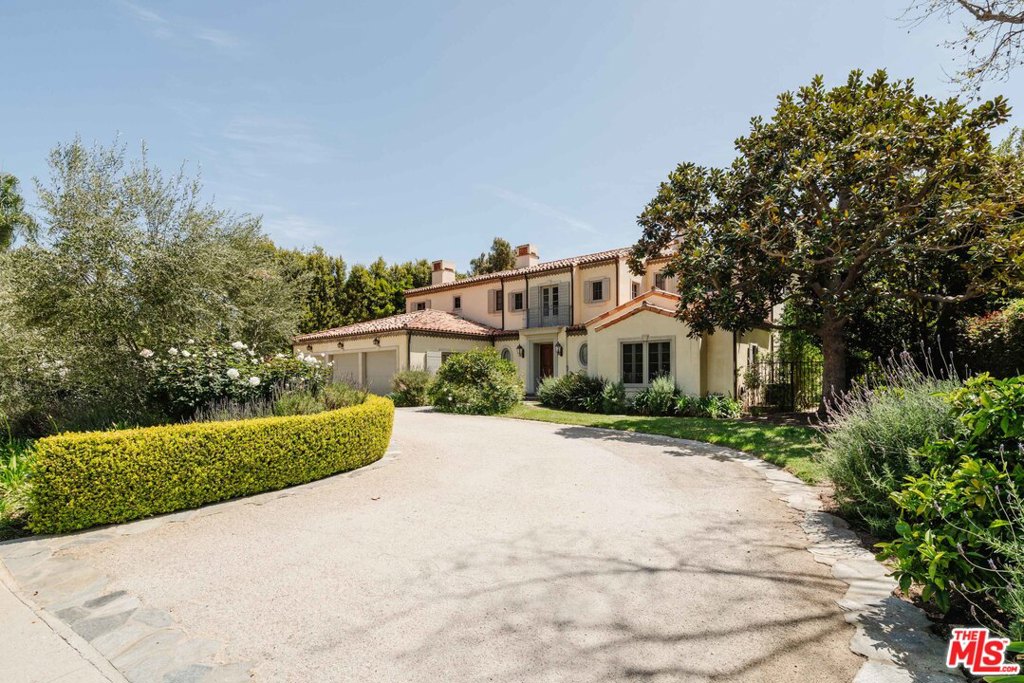 Set on an expansive flat lot abutting the Riviera Country Club in the coveted Palisades Riviera, this remarkable private estate is reminiscent of a Southern French country home. Built in 2001 by Thomas Callaway, the timeless residence enjoys contemporary touches and incorporates hardwood floors, wood-beamed ceilings, and wood-burning fireplaces. Via a circular driveway, guests enter the home through a grand two-story entry, setting the tone for the sun-drenched, open, and relaxed flow. The first level boasts a dining room, family room, formal living room, home office, laundry room, a lower bedroom suite, pantry, and chef's kitchen with island and top-of-the-line appliances. Upstairs, the generous master suite features two large walk-in closets, a spa-like bathroom with separate shower and tub, fireplace, and balcony overlooking the resort-like backyard. Three other en-suite bedrooms, including a junior master suite, complete the upper level. Venture outside through multiple sets of French doors to the large loggia with outdoor dining, BBQ, and entertaining areas, leading out to the awe-inspiring backyard with an enormous yard, pool, and spa. The home is completed by a three-car garage.
