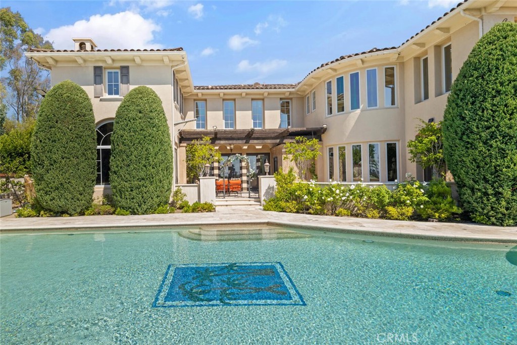 Welcome to 11755 Collar Ave. This luxurious oasis is nestled in one of the most coveted locations within the prestigious 24-hour guard-gated community of Tustin Ranch Estates. This stunning 5,900+ sq. ft. residence offers breathtaking views, mesmerizing sunsets, and picturesque vistas of Catalina Island, all from a peaceful, single-loaded cul-de-sac street. Situated on a sprawling 16,000 sq. ft. lot, the home boasts a seamless blend of elegance and privacy. With its spacious layout, upscale finishes, dual staircase, and panoramic surroundings, this estate invites you to experience an unparalleled lifestyle of comfort and sophistication. This former builder’s model home was thoughtfully designed with premium upgrades, offering a luxurious yet comfortable living space. Every detail has been meticulously crafted to elevate the home's elegance, from high-end finishes to custom features, providing an exceptional blend of style and functionality. Whether enjoying the expansive indoor areas or the breathtaking outdoor views, this home delivers an unparalleled living experience. The kitchen is a chef's dream, featuring custom-made cabinetry and ample storage. Equipped with a double oven, built-in refrigerator, and a 6-burner cooktop, this space is designed for both cooking and entertaining with ease. On the first floor, you'll find a primary en-suite, a formal study with a fireplace, a bright family room, a breakfast nook, and a formal living room with an astonishing wood-carved fireplace and cathedral ceilings. A formal dining room and a bar enhance the home's entertainment capabilities. The master suite on the second floor boasts its own viewing balcony, offering stunning ocean and city views. 3 additional en-suite bedrooms & a large playroom cater to the needs of the whole family. The mature front & rear gardens offer a year-round spring-like atmosphere. Additional amenities include a covered patio with stone fireplace, overhead heaters, a ceramic-tiled swimming pool, hot spa, and a fully equipped BBQ area offering a massive grill. The long driveway provides parking for multiple cars. The gold-ribbon award-winning schools, world-class dining and shopping, John Wayne Airport, and freeways are all in close proximity.