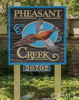 Charming and well-maintained upper-level 2-bedroom, 2-bathroom condo in the tranquil Pheasant Creek Community. This inviting living area features vaulted ceilings, tile flooring throughout, ceiling fans, recessed lighting, and direct access to a private balcony with a washer and dryer room, creating a bright and airy living space. The spacious primary suite includes two large closets, while the secondary bedroom also offers generous storage. The updated kitchen is appointed with granite countertops, recessed lighting, and tile flooring. This Condo has assigned one carport and one open space. Community amenities include multiple pools and spas, a picnic area, tennis and sports courts, and access to nearby walking and hiking trails. HOA dues cover water, trash, and exterior maintenance. Ideally located close to Saddleback Church, shopping center, parks, schools, and major commuter routes.