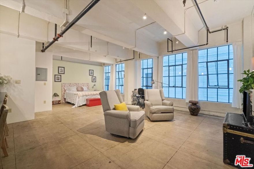 Own a piece of Los Angeles history and enjoy substantial annual savings. Under the coveted Mills Act, homeowners in this historic building receive approximately 60-70% off annual property taxes, freeing up funds each year for other homeownership goals. Set within the historic Cornell Building in DTLA's vibrant Santee Village and Fashion District, this sophisticated 1-bedroom, 1-bathroom industrial loft blends timeless architectural character with modern comfort. Wall-to-wall windows and an expansive open floor plan create an inviting space. The massive kitchen island is perfect for cooking, entertaining, or working from home, while the in-unit washer and dryer add everyday convenience. Enjoy resort-style amenities including a rooftop pool, three spas, basketball court, putting green, BBQ area, luxury fitness center, and even a street-level convenience market. The building also features 24-hour live security, secure code/fob access, and gated assigned parking in the secured Maple Avenue Garage with a convenient shuttle service to the front of the building included in the HOA fee. A 6' x 9' storage unit is available to rent for additional space (dependent on availability). Perfectly positioned near DTLA's best restaurants, bars, boutiques, and entertainment venues, this home offers a rare combination of historic charm, luxury amenities, and unbeatable value. The building is Fannie Mae, FHA, and VA approved! The HOA covers water, gas, sewer, trash, parking, and 24-hour security. Short term rentals allowed! A truly unique opportunity to own in one of Downtown LA's most celebrated Mills Act buildings where architectural history meets modern, resort-style living.