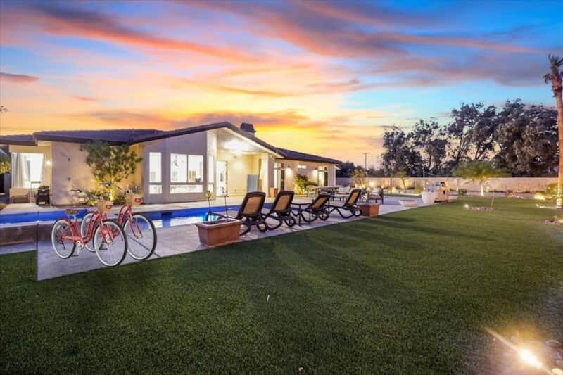 Welcome to your ultimate desert retreat! This custom-built, 7-bedroom, 3.5-bath home sits on over an acre of private, gated land, offering incredible mountain views and city lights. Recently remodeled in 2020, the estate is turn-key furnished and ready for your family or group to enjoy. The expansive backyard features a newly redone pool, jacuzzi, beach volleyball court, and RV parking. Designed for fun and relaxation, the home also boasts an attached casita/game room and a dedicated movie room for endless entertainment. Each bedroom is spacious and comfortable, making it ideal for large groups. The open floor plan seamlessly connects the living, dining, and kitchen areas, creating a perfect space for gatherings and celebrations. Whether you want to relax by the pool, play volleyball, or host a movie night, this estate offers everything you need for an unforgettable stay. With no immediate neighbors, you'll enjoy ultimate privacy while soaking in the desert lifestyle. Perfect for family get-togethers or a fun group getaway, this retreat truly checks all the boxes for a dream vacation. Book now for an unforgettable desert escape! Rates are subject to change. All stays are 30 days minimum or longer unless stated otherwise. Information provided is deemed reliable but interested parties must verify all related to square footage, utilities, etc. Investments carry risk including of your principal.