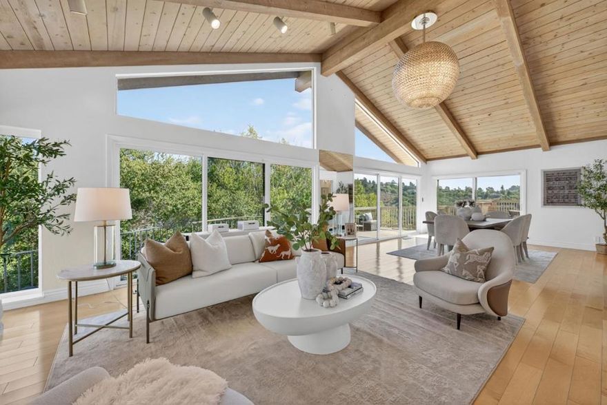 Perched in the prestigious Lakeview neighborhood of Hillsborough, this gated residence blends refined living with breathtaking design and panoramic views. A spacious motor court and two-car garage welcome you to a home of distinction. Step into the elegant foyer, where classic columns frame a soaring open-concept living area. Vaulted ceilings with exposed beams and floor-to-ceiling windows flood the space with natural light and showcase sweeping vistas. The expansive living room features a dramatic stone fireplace and flows into a chefs kitchen with high-end stainless steel appliances, tray ceiling, and a generous breakfast barperfect for everyday living and entertaining. This four-bedroom home includes a luxurious primary suite with a private sitting area and spa-inspired bath, complete with soaking tub, frameless glass shower, and double vanity. Located in the serene Lakeview area near top-rated schools, boutique shopping, and dining, with easy access to Hwy 280, 101, SF, Silicon Valley, and SFO. The land has potential for subdivision, subject to city approval.