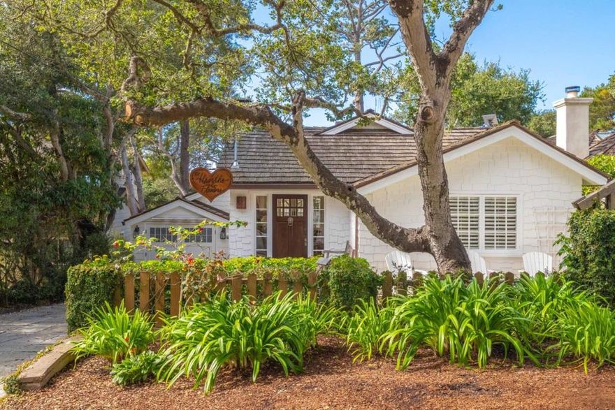 Nestled in the Golden Rectangle and just a short stroll from Carmel Beach, this coastal cottage has been thoughtfully reimagined to blend classic Carmel character with upscale modern living. Step inside to discover a light-filled living space anchored by a rustic stone fireplace, creating the perfect setting for cozy evenings or relaxed entertaining. The stylish, updated kitchen flows seamlessly into the open living area, while a charming loft above adds a whimsical touch, ideal as a reading nook, creative space, or guest area. The private primary suite offers a peaceful retreat with a spacious walk-in closet, while a beautifully appointed guest suite ensures comfort for visitors. A third bedroom, paired with a convenient half bath, is perfectly suited for a home office or additional overnight guests. Every corner of this home is enhanced with custom finishes and details that elevate its sense of luxury. Enjoy ocean glimpses from the balcony or unwind in the lush, landscaped backyard, an ideal setting for alfresco dining or entertaining. This hidden gem is the perfect Carmel retreat, ideally situated to enjoy the best of Carmel-by-the-Sea's vibrant downtown and scenic coastline.