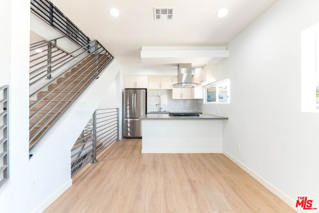 Welcome home to 756 Ridgewood Place-- a front-facing showpiece in a freshly built 4-plex in the heart of Hollywood. This spacious 3-bedroom, 2.5-bath townhouse blends modern design with thoughtful detail, offering comfort, light, and flow in all the right places.From the moment you enter, either through the vivid orange-accented front door or directly from your private garage, you'll feel the intention in every detail. The first floor leads you upward into a beautifully designed living space where the kitchen and lounge area feel both open and intimate, with natural light pouring in and a subtle elegance in the layout. There's even a formal dining nookrare for townhomes in this areathat adds a touch of charm and flexibility.Upstairs, each bedroom has its own en suite bathroom and a walk-in closet already built out for you. The primary bath is a treat, ready for your first bubble bath moment. And yes, your washer and dryer are already tucked neatly upstairs where they belong. Everything is brand new, fresh, and waiting for your firstsfirst coffee with a view of the Hollywood sign, first dinner with the windows open, first night of sleep in a space that's never held anyone else's story.Every unit in this complex has its own unique character, but 756 gets the front row. If you've been looking for something that doesn't feel like every other place on the market, this just might be the one. Let it be yours before someone else gets the keys. Located on a quiet, tree-lined street just moments from Paramount Studios, Larchmont Village, and Hollywood's best cafes and creative energy, 756 Ridgewood Place puts you right in the mixwithout the noise