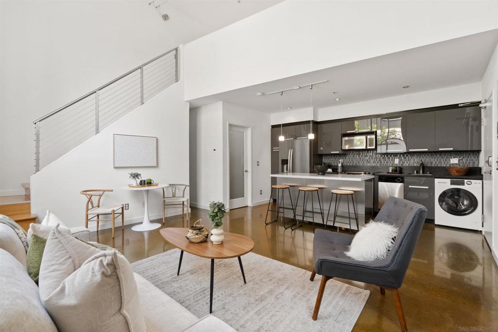LOCATION, LOCATION, LOCATION! Urban living in the heart of East Village. This rare walk-up loft at Moto Villas—designed by award-winning architect Jonathan Segal—features 18-foot ceilings, south-facing windows, and a spacious, open layout filled with natural light. The home includes a private street-level entrance, enclosed patio, remodeled kitchen and bath, in-unit laundry, fresh paint, and a new smart-controlled Solus heater. Moto Villas is a boutique community offering low HOA dues (LOWEST HOA FEES in any downtown community!) and assigned parking. Located steps from Petco Park, grocery stores, cafes, and more—this is downtown living with style, efficiency, and unbeatable convenience.