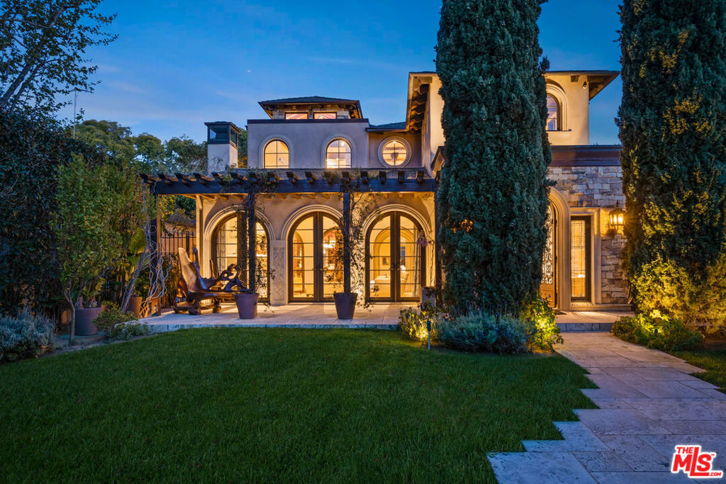 Welcome to 506 Palisades Ave, an elegant Tuscan retreat ideally situated a short stroll to Montana Ave's shops & dining and world class beaches. Beyond privacy hedges and lush grounds, enter the home and appreciate old-world craftsmanship & materials such as custom stone & wood work, beamed ceilings, arched doorways, and detailed built-ins, molding and trim. A double-height foyer connects to grand living spaces including a spacious living room with vaulted ceiling, formal dining room, stately home office, and comfortable family room. The chef's kitchen with island and breakfast room walk out to a peaceful garden, dining terrace with built-in BBQ, and saltwater pool & spa with waterfall. Upstairs a luxe primary suite boasts two walk-in closets, fireplace, and a spa- like bathroom. The basement level exudes sophistication and style, featuring an entertaining lounge with wet bar accentuated by wine racks, fireplace, and ceilings adorned in brick. Enjoy your favorite film in the plush theatre with recliner seating for eight. With seven bedrooms in the main residence plus a charming detached guest house, your family and visitors are afforded complete comfort and privacy. Home can also be purchased furnished with most furniture available as per listing photos. Furniture not included in listing price.