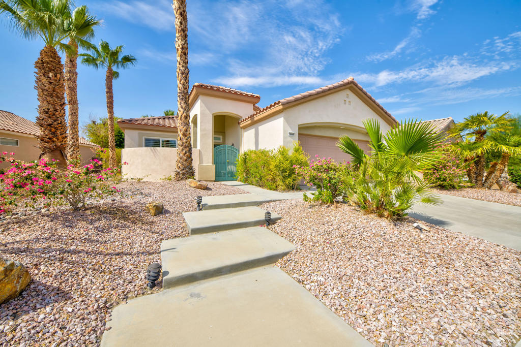 Sun City Palm Desert ''Cayman'' Model 2/2+ Den with pocket doors can be an optional 3rd bedroom. Located in the new section near Lakeview Clubhouse. Custom courtyard wall with security gate gives this unique home great curb appeal! Wide hallways open to the Great Room floor plan with 9' and 10' ceilings. Custom wallpaper & paint, smooth finish Plantation Shutters, 16'' tile floors, carpet in bedrooms, and ceiling fans are through-out. New HVAC 2024, water heater and disposal. Island Kitchen with granite tile countertops, stainless appliances and new LED canned lighting. Primary suite with a french door that opens to the rear patio, bath has a seated vanity, step-in shower and walk-in closet. Guest bedroom & bath with shower/tub combo. The South facing backyard has an extended aluma-wood covered patio, fruit trees and custom concrete hardscape in the front & back. Indoor laundry with newer front load washer/dryer and a 2 car garage.