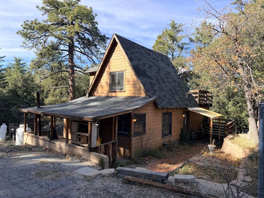 Set on a generous 0.31-acre lot, this 1-bedroom, 1.5-bathroom home offers 908 square feet of potential in the heart of Idyllwild. Built in 1975, this property is a true fixer project perfect for buyers looking to customize and update to their own taste. The bright living area features a classic fireplace for cozy evenings, while a separate laundry room adds convenience. Step outside to a private deck and patio, surrounded by tranquil mountain scenery. With its functional layout and abundant natural light, this home is ideal for those seeking a rewarding renovation opportunity, whether as a full-time residence or a peaceful weekend retreat. Bring your vision and transform this mountain cabin into your dream getaway.