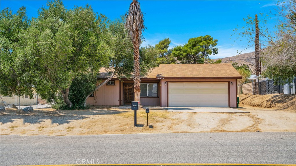 Welcome to this versatile 2-bedroom, 2-bathroom home in the heart of Morongo Valley. Perfectly located just across the street from the elementary school. The property comes with fully paid-off solar, helping you save on energy costs year-round. This home features central heating and air with an added bonus room in the garage, potentially for a home office, guest room, or creative space. With some cosmetic work, this home has plenty of opportunity to make it your own. The large, fenced backyard is great for kids, pets, or entertaining under the desert sky. This home in Morongo Valley is conveniently positioned between Joshua Tree and Palms Springs for endless possibilities. Whether you're a first-time buyer, investor, or someone looking for a peaceful retreat with room to grow, this home is a must-see!