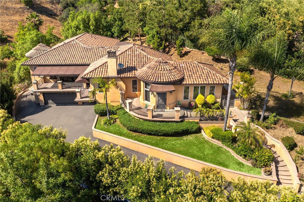 Welcome to this stunning Mediterranean style estate nestled in the serene hills of La Habra Heights. Crafted in 2008, this architectural masterpiece boasts a level of luxury that is simply unparalleled. As you enter through the private gate, you'll be greeted by a beautifully landscaped driveway adorned with an abundance of trees, setting a tranquil ambiance. Step inside and be captivated by the breathtaking interior, featuring soaring high ceilings, exquisite crown moldings, and rich classic hardwood floors that flow seamlessly throughout the house. Every detail has been carefully considered, creating an atmosphere of refined elegance. The master bedroom is a true retreat, offering an expansive space, an enormous closet, and a luxurious bathroom, providing the perfect sanctuary for relaxation. Designed with an open floor plan, this home allows for seamless flow and effortless entertaining. The stunning balconies offer picturesque views of the surrounding canyon, mountains, and the city below, allowing you to immerse yourself in the natural beauty that surrounds you. The allure of this property continues outside, as magnificent double French doors lead to romantic patios and a spacious backyard, perfect for enjoying the outdoors in style. The meticulously manicured grounds provide a private oasis for outdoor gatherings and leisurely strolls. Additionally, this property offers the unique opportunity for monthly royalties income. Despite its secluded landscape, this home's prime location ensures that you remain conveniently close to the city, striking the perfect balance between privacy and accessibility. Prepare to have your expectations exceeded and experience the joy of coming home to a place that truly embodies luxury and tranquility. Indulge in the ultimate living experience and make this extraordinary estate your own.