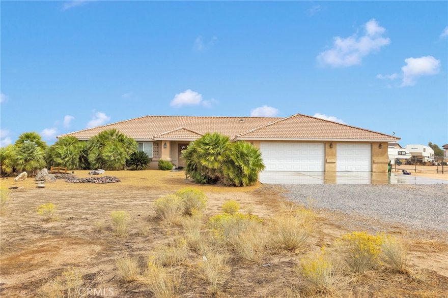 This move-in ready, extremely well-maintained 4-bedroom, 3-bath home sits on 2.5 fully fenced and cross-fenced acres with breathtaking mountain views. Inside, you’ll find vaulted ceilings and a large living room featuring a beautiful brick gas fireplace, built-in shelving with accent lighting, and an open, inviting layout. The split floor plan offers privacy, with three bedrooms and a full bathroom on one side and a huge master suite on the other—complete with a luxurious ensuite living area, that leads to private patio, large bathroom with garden tub, dual sinks

The open kitchen is a cook’s dream, featuring a 5-burner stove, microwave/convection oven combo, tons of cabinet space, under-cabinet lighting, two pantries (including one large walk-in), and a bar area perfect for casual seating.

Step outside to enjoy a relaxing gazebo area, a 30x20 detached garage/workshop with electricity, and a 40-ft storage container. The property also includes an oversized 3-car garage, an RV pad with 50-amp power, and multiple double gates for easy access. Water spigots are conveniently located on all sides of the home.

situated on a well-maintained 0.3-mile dirt road, this home is in one of the lowest-cost water districts in Apple Valley—and you’ll love the added bonus of not needing to pay for trash service (if buyers prefer) because this home comes with a dump card. This property has so much to offer!