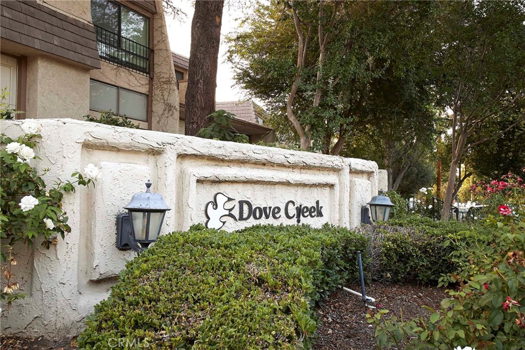 Welcome to Dove Creek—Where Comfort Meets Convenience. Step into this light-filled 3-bedroom, 2.5 bath townhouse offering over 1,750 sq ft of airy living space with soaring ceilings and an open layout designed for modern living. The primary suite features a private ensuite bathroom, while the flexible third bedroom loft includes a built-in desk and storage—ideal for a home office, guest room, or creative retreat. Enjoy seamless indoor-outdoor living with sliding glass doors opening to your own private courtyard. The spacious kitchen boasts ample cabinetry, an entertainer's wet bar, and flows into a freshly painted interior. The attached 2-car garage includes dedicated laundry space for added functionality. Dove Creek offers resort-style amenities including a heated pool, two hot tubs, two tennis courts, and meticulously landscaped grounds—all set in a serene, well-maintained community. Located minutes from The Village, Westfield Topanga, Woodland Hills Recreation Center and the 101 freeway, this home places shopping, dining, and nature right at your fingertips. Schedule your private tour today.