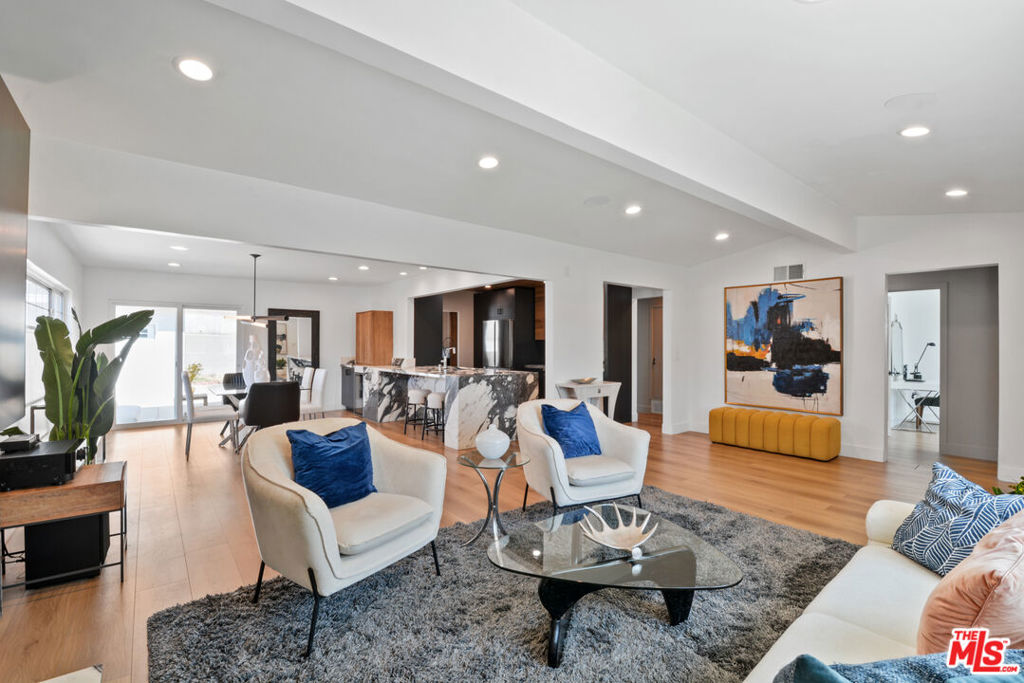 Look no further, this is it! Fully remodeled Mid Century Modern Gem in a top rated school district! Open concept living, premium wood floors + a flood of natural light set the tone for refined elegance in this private entertainers paradise. This gorgeous home offers 3 bedrooms + 2 beautiful bathrooms with modern vanities, quartz counters and custom tile decor. The heart of the home, its stunning kitchen, features newer cabinetry, a tongue and groove ceiling, stainless steel appliances, and a massive Calacatta Carbone marble island/breakfast bar that anchors the space with sophistication and function. Entertain effortlessly in the generous dining area, perfectly suited for hosting holiday gatherings, complete with a custom built gourmet coffee bar for your morning rituals or evening wind downs. The living room is a showstopper with a custom built TV cabinet, a premium audio visual system, and a marble adorned fireplace that adds both warmth and style. A dedicated laundry room offers side by side full sized washer and dryer units, accented by a wall of elegant tilework. Glass doors in the dining room lead to a cozy covered patio and a private grass yard with NO NEIGHBOR behind the home- ideal for al fresco dining, weekend lounging, or letting kids and pets play freely. A gated dog run along the side of the house adds even more convenience for pet lovers. The oversized two car garage offers flexible space whether used as a gym, studio, or entertainment room while the long driveway easily accommodates five cars. With central AC and heat, every comfort is considered. *Highly desirable Los Altos neighborhood - walking distance to William F. Prisk Elementary , Stanford Middle School and the North Los Altos shopping center. Backyard has been virtually staged with furniture/planters and grass color was enhanced. Broker and agents do not represent or guarantee the accuracy of the square footage, income, expenses, condition, development potential, bedroom/ bathroom count, lot size or lot lines, dimensions, permitted or non-permitted spaces, or school eligibility. Buyer is advised to independently verify the accuracy of all information with appropriate professionals. There are no warranties or guarantees, buyer to rely solely on his/her/their own findings. Contact L/A 1 to schedule a showing. *See Virtual Tour