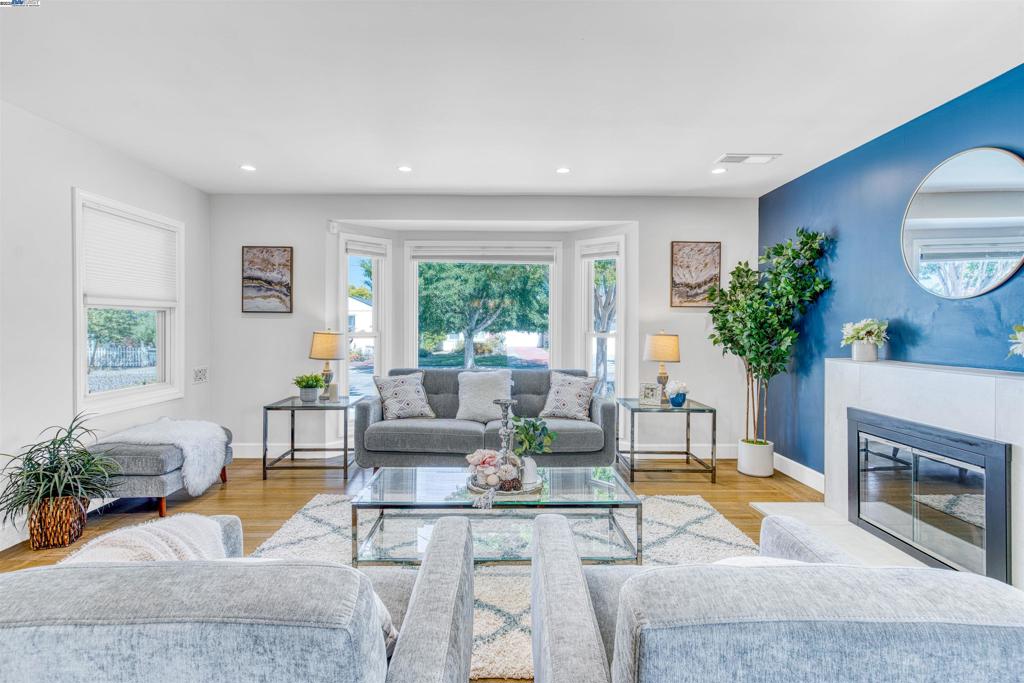 Gem in a serene, tree-lined neighborhood. Beautifully renovated 3-bedroom, 3-bath home plus a permitted fully detached 1-bedroom, 1-bath ADU with its own street address. The main house underwent a extensive renovation in 2021 and features a bright, open-concept floor plan. The modern kitchen is outfitted with high-end finishes, sleek wine cooler, two sinks (a double and a large work sink in the island/breakfast bar), spacious pantry with soft-close cabinetry, and a versatile nook perfect for home office or second pantry. Each bedroom includes its own en-suite bathroom for ultimate privacy and convenience. Refinished hardwood floors, upgraded double-pane windows, and cordless blackout top-down/ bottom-up cellular shades add comfort and style throughout. The detached ADU offers complete independence with a full kitchen, separate washer & dryer, and private entry—ideal for guests, long-term rental, or multi-generational living. Enjoy low-maintenance front and back yards in a clean, peaceful, and quiet neighborhood. Conveniently located near downtown San Leandro, close to shopping, dining, major commute routes, and BART.