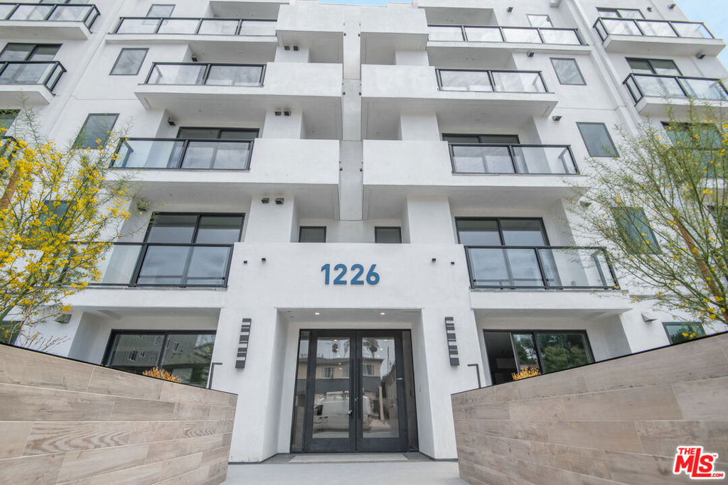 Penthouse-Level Corner Condo in New Luxury Building in Prime Pico-Robertson Location! Experience elevated city living in this sun-drenched top-floor 3-bedroom, 3.5-bath corner penthouse in an upscale, newly constructed building. Residence 504 sits on the fifth-floor penthouse level, offering enhanced privacy, minimal common walls, and sweeping neighborhood views. The open-concept layout is perfect for modern living, with high ceilings, abundant natural light, and a private balcony for seamless indoor-outdoor flow. The sleek, contemporary kitchen is a chef's dream, featuring European-style cabinetry, quartz countertops, a professional-grade appliance suite, a five-burner cooktop, a double oven, and a stylish double-basin sink. The spacious primary suite includes a walk-in closet with custom-built-ins and a luxurious en-suite bath outfitted with quartz finishes, porcelain tile, and Delta fixtures. Two additional bedrooms offer ideal space for guests, a home office, or a growing household. Smart-home features include a Nest thermostat, smart wiring, an in-unit LG washer/dryer, and wide-plank modern flooring throughout. This residence includes tandem parking in a secure garage and is part of a limited collection of just 20 corner units, ensuring peace, privacy, and an exclusive feel. Located moments from the heart of Pico-Robertson with easy access to Beverly Hills, Century City, and the 10 Freeway.
