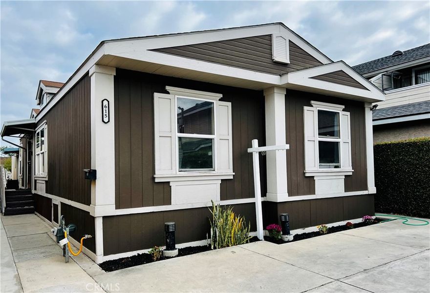 Location! Location! Location! Great opportunity to own a mobile home in a prime location at a park with a low monthly space rent $1,350. Built in 1996 this Double wide Mobile home Features 3 bedrooms and 2 bathrooms. Once you walk in, you are welcomed by a spacious open floor plan. The skylight in the kitchen and in the living room make the inside of the home bright and inviting. The Vaulted Ceilings in the living room give the home a spacious feeling. The living room also has a built in bookcase.  The home has Tile floor in kitchen, dining , bathrooms and living room. All bedrooms feature Laminate wood. The primary bedroom has its own private bathroom with jacuzzi!! and a walk in closet. The Kitchen is open to the living room and features a breakfast bar and dining area great for family gatherings. It also has a pantry cabinet for extra storage.  The Location of this mobile home in park is in the corner, therefore there is only 2 adjacent neighbors. This mobile home is conveniently located near shopping, dining,  entertaining, freeway 91,57 and minutes access to the 5 freeway! Make this mobile home your today!