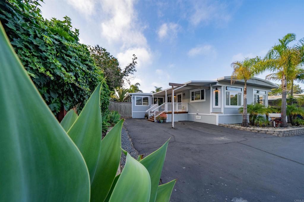 THIS IS NOT YOUR TYPICAL RIVIERA LOT! LOCATION! LOCATION! PRIVATE LANE WITH PARK LIKE MATURE TREES AND HUGE HUGE HUGE BACKYARD THAT HAS BEEN IMPROVED! Coastal Living at Its Finest in Leucadia! Welcome to this beautifully remodeled single-level beach home, perfectly situated just steps from the sand in the heart of vibrant Leucadia. This 1,680 sq. ft. home lives like a single-family residence, offering a seamless blend of modern updates and laid-back coastal charm—ideal for stylish everyday living, effortless entertaining, and the perfect family home. Officially a 2-bedroom, 2-bathroom layout plus a huge bonus room with generous closet and sliding doors opening to the deck and expansive backyard. Nestled on a private corner lot with park-like mature trees, this home boasts a massive, professionally improved backyard—unlike any typical Rivera lot. The open-concept floor plan is flooded with natural light and showcases stunning custom vinyl plank flooring installed in 2022. The spacious gourmet kitchen, the heart of the home, features sleek countertops, ample cabinetry, and a large island that flows effortlessly into the living and dining areas—an entertainer’s dream. Every detail has been thoughtfully upgraded: a new insulated metal roof (2022), a new furnace (2023), and a fully upgraded electrical panel with a dedicated 30-amp circuit for electric vehicle charging. Energy efficiency and comfort are enhanced with LED lighting throughout, ceiling fans in each bedroom, and fresh interior and exterior paint completed in 2024. The master bathroom, recently remodeled, boasts a huge soaker tub, separate shower, dual sinks and ample storage space. Custom tile and updated fixtures for a luxurious, modern retreat finish this luxurious retreat. The second bathroom has also been tastefully remodeled with custom tile, circular shower and contemporary fixtures. Step outside to your private backyard oasis, professionally landscaped with a full sprinkler system, a built-in gas fire pit, and a custom-built BBQ area—perfect for enjoying warm evenings and coastal breezes. Families will love the access to top-rated schools, making this an ideal home for growing households. Just steps from Beacon’s Beach and moments from Leucadia’s world-class eclectic boutiques, renowned restaurants, and vibrant nightlife, this home offers a rare opportunity to embrace the quintessential Encinitas beach lifestyle with every modern convenience in place.